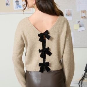 Elegant Beige Sweater with Black Velvet Bow Accents
